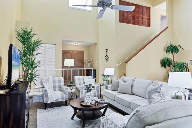 175 Inlets Blvd Unit 175, Nokomis, FL 34275 - living room featuring a high ceiling, ceiling fan, carpet floors, and stairway