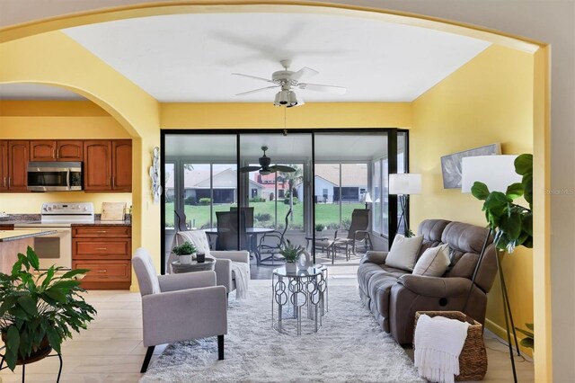 175 Inlets Blvd Unit 175, Nokomis, FL 34275 - living room featuring ceiling fan and arched walkways