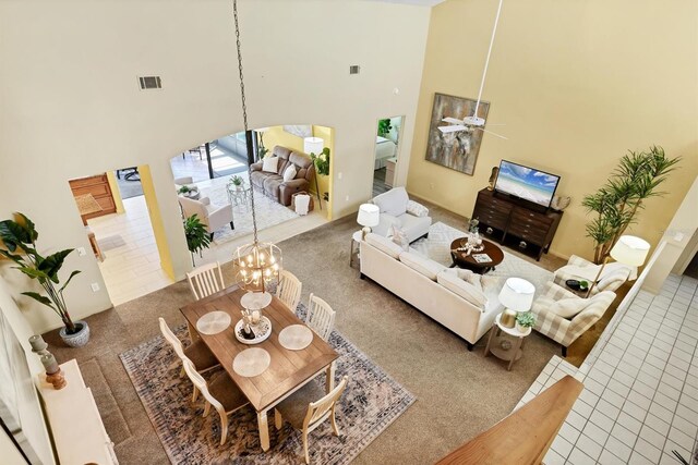 175 Inlets Blvd Unit 175, Nokomis, FL 34275 - tiled living area featuring a towering ceiling, carpet, ceiling fan, and a chandelier