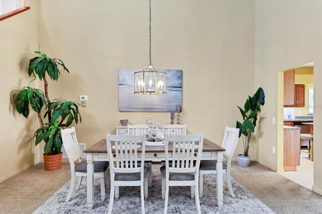 175 Inlets Blvd Unit 175, Nokomis, FL 34275 - dining room with light colored carpet, a chandelier, and a high ceiling