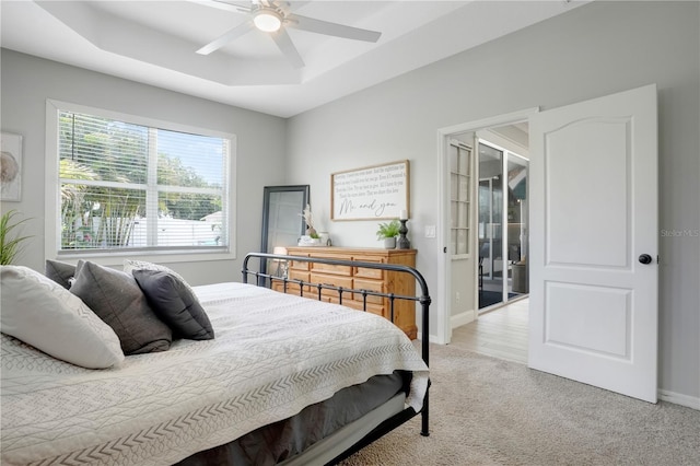 5419 Lakehurst Ct, Palmetto, FL 34221 - bedroom featuring light carpet, a raised ceiling, and ceiling fan
