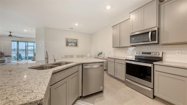 17817 Pastureland Ave, Lakewood Ranch, FL 34211 - kitchen with stainless steel appliances, gray cabinets, tasteful backsplash, a ceiling fan, and recessed lighting