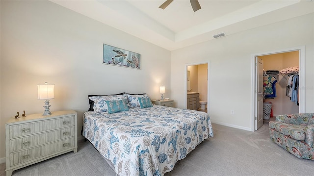 17817 Pastureland Ave, Lakewood Ranch, FL 34211 - carpeted bedroom with a walk in closet, ensuite bath, a closet, a ceiling fan, and a tray ceiling