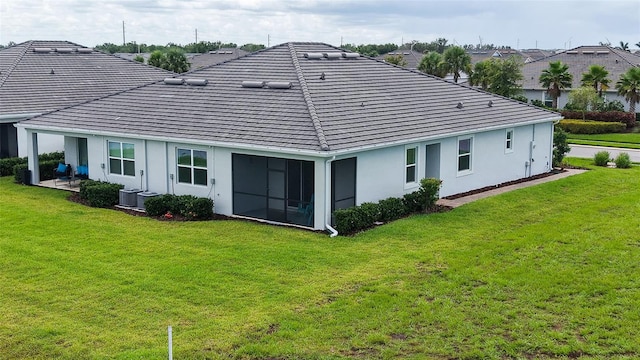 17817 Pastureland Ave, Lakewood Ranch, FL 34211 - rear view of property with a lawn, stucco siding, and a tile roof