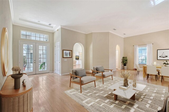 5839 Los Verdes Ct, Bradenton, FL 34210 - living room with arched walkways, light wood finished floors, a towering ceiling, and french doors