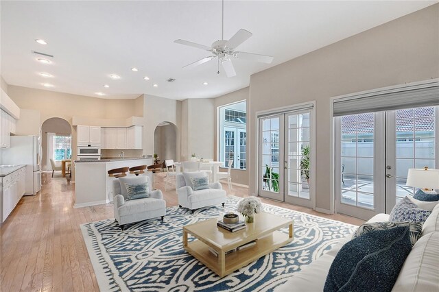 5839 Los Verdes Ct, Bradenton, FL 34210 - living area featuring arched walkways, french doors, ceiling fan, light wood finished floors, and recessed lighting