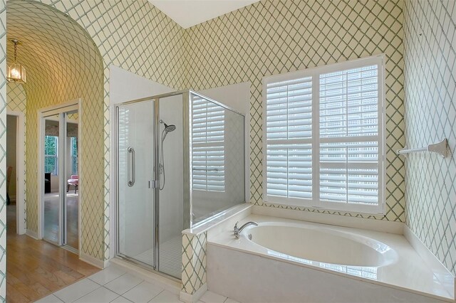 5839 Los Verdes Ct, Bradenton, FL 34210 - bathroom with wallpapered walls, a garden tub, a stall shower, and tile patterned floors