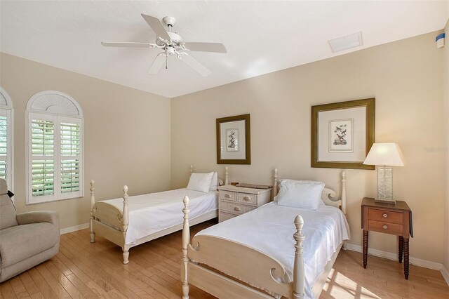 5839 Los Verdes Ct, Bradenton, FL 34210 - bedroom with light wood finished floors and a ceiling fan