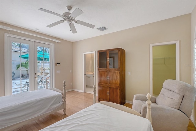 5839 Los Verdes Ct, Bradenton, FL 34210 - bedroom with french doors, access to outside, light wood-style floors, a ceiling fan, and ensuite bathroom