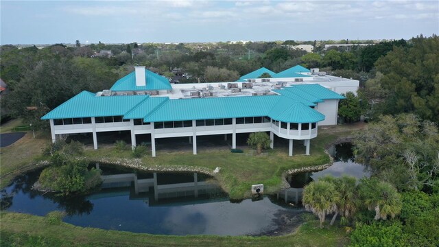 5839 Los Verdes Ct, Bradenton, FL 34210 - rear view of house featuring a water view, a chimney, and a metal roof
