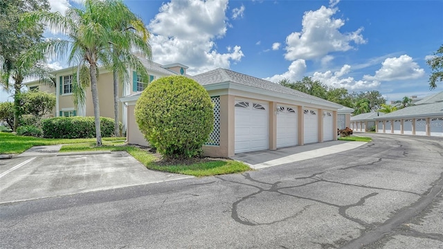 4211 Caddie Dr E Unit 202, Bradenton, FL 34203 - view of property exterior with community garages and stucco siding