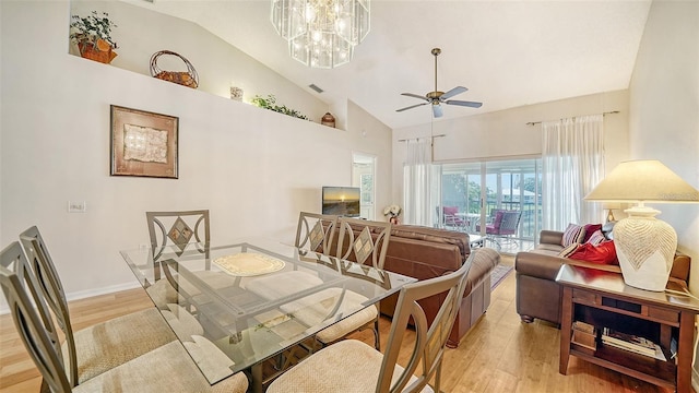 4211 Caddie Dr E Unit 202, Bradenton, FL 34203 - dining area with light wood-style flooring, high vaulted ceiling, a ceiling fan, and a chandelier
