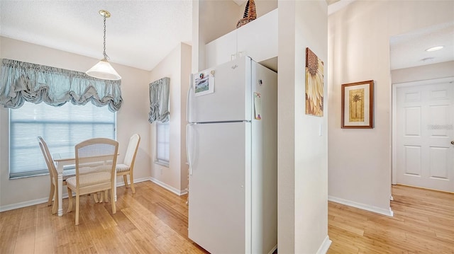 4211 Caddie Dr E Unit 202, Bradenton, FL 34203 - dining area featuring light wood finished floors and lofted ceiling