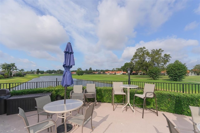 4211 Caddie Dr E Unit 202, Bradenton, FL 34203 - view of patio with golf course view, outdoor dining area, and a water view