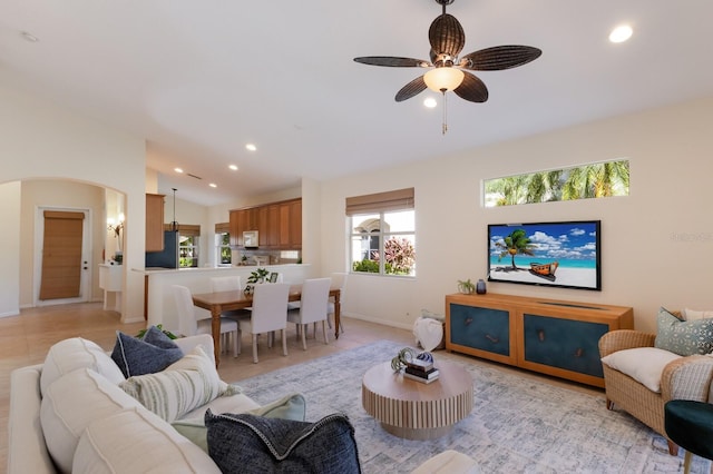 7419 Birds Eye Ter, Bradenton, FL 34203 - living room with arched walkways, ceiling fan, recessed lighting, lofted ceiling, and light tile patterned floors