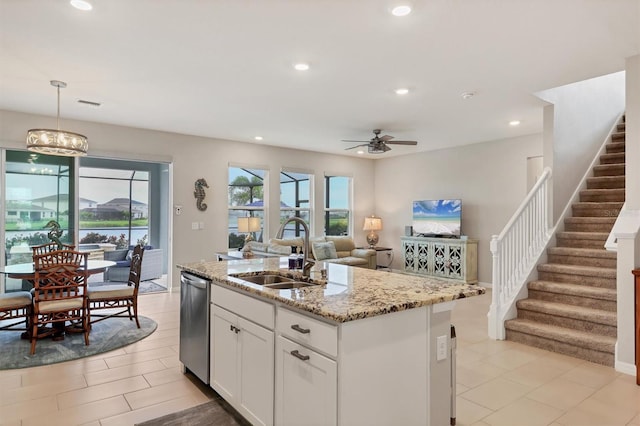 12564 Night View Dr, Sarasota, FL 34238 - kitchen with a ceiling fan, light stone counters, a kitchen island with sink, recessed lighting, and white cabinetry