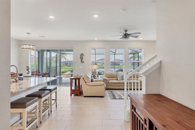 12564 Night View Dr, Sarasota, FL 34238 - living room featuring a ceiling fan, recessed lighting, and stairway