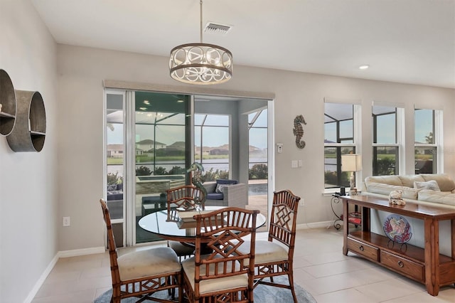 12564 Night View Dr, Sarasota, FL 34238 - dining space with a chandelier, light tile patterned floors, recessed lighting, and a water view