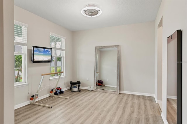 12564 Night View Dr, Sarasota, FL 34238 - exercise area with wood finished floors and baseboards