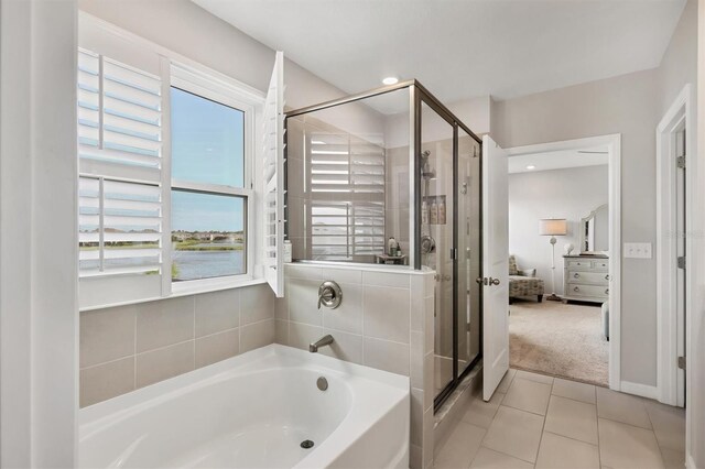 12564 Night View Dr, Sarasota, FL 34238 - full bathroom with a garden tub, plenty of natural light, a shower stall, and tile patterned floors