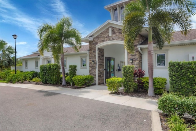12564 Night View Dr, Sarasota, FL 34238 - view of front facade featuring stone siding, stucco siding, and a shingled roof