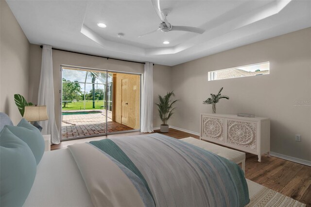 2148 Date Palm Way, Venice, FL 34292 - bedroom featuring a tray ceiling, access to exterior, wood finished floors, recessed lighting, and a ceiling fan