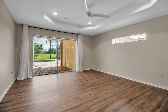 2148 Date Palm Way, Venice, FL 34292 - spare room featuring a tray ceiling, wood finished floors, a ceiling fan, recessed lighting, and a smoke detector