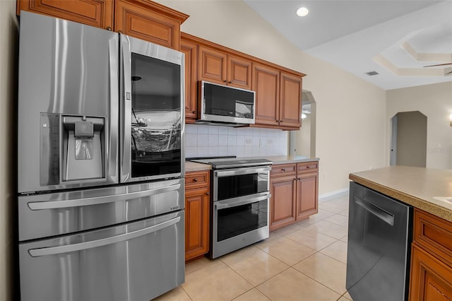 2148 Date Palm Way, Venice, FL 34292 - kitchen featuring appliances with stainless steel finishes, a skylight, brown cabinets, and recessed lighting