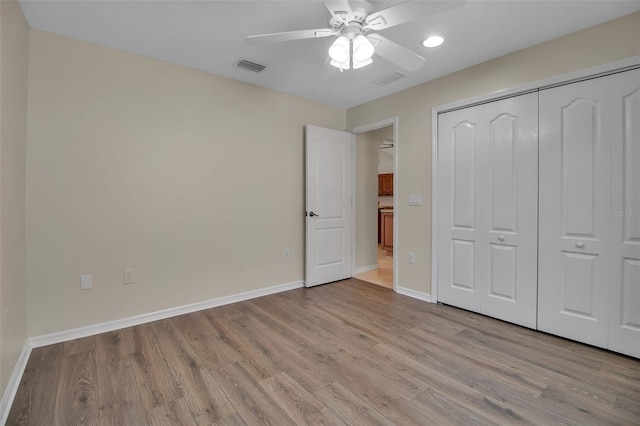 2148 Date Palm Way, Venice, FL 34292 - unfurnished bedroom with light wood-style floors, a closet, ceiling fan, and recessed lighting