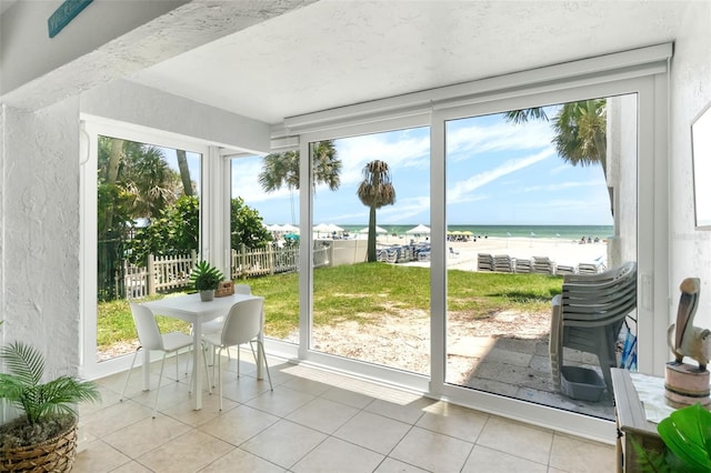 6312 Midnight Pass Rd Unit 102S, Sarasota, FL 34242 - sunroom with healthy amount of natural light, tile patterned flooring, a water view, and a textured wall