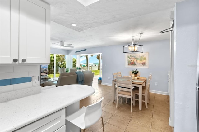 6312 Midnight Pass Rd Unit 102S, Sarasota, FL 34242 - dining area with light tile patterned floors, a chandelier, and ceiling fan