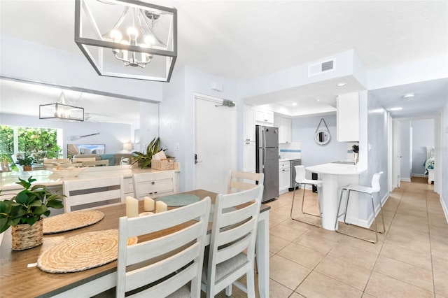 6312 Midnight Pass Rd Unit 102S, Sarasota, FL 34242 - dining area featuring a chandelier and light tile patterned floors