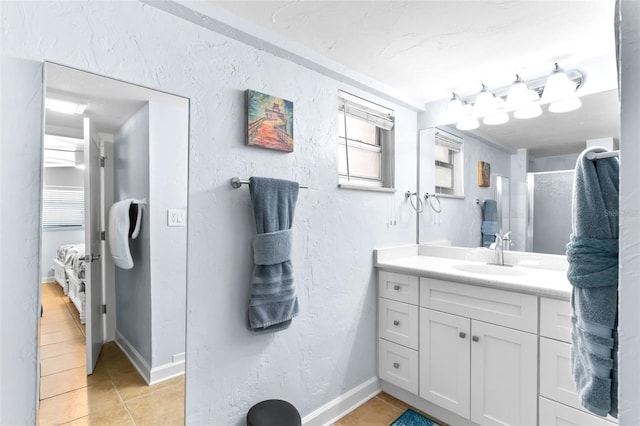 6312 Midnight Pass Rd Unit 102S, Sarasota, FL 34242 - bathroom with tile patterned floors, vanity, a textured wall, and a shower