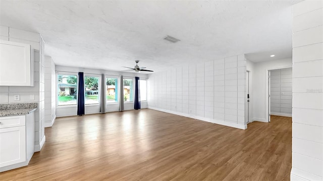 4455 Emerald Ridge Dr, Sarasota, FL 34233 - unfurnished living room with light wood-style floors, ceiling fan, and recessed lighting