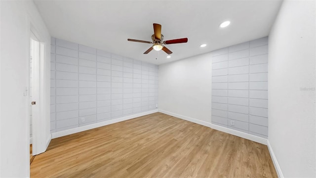 4455 Emerald Ridge Dr, Sarasota, FL 34233 - empty room featuring ceiling fan, light wood-style floors, recessed lighting, and tile walls
