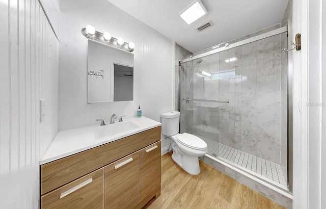 4455 Emerald Ridge Dr, Sarasota, FL 34233 - bathroom with wood finished floors, vanity, and a shower stall