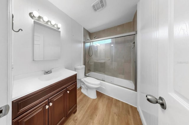 4455 Emerald Ridge Dr, Sarasota, FL 34233 - full bathroom with wood finished floors, vanity, and enclosed tub / shower combo