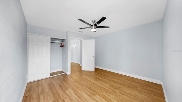 4455 Emerald Ridge Dr, Sarasota, FL 34233 - unfurnished bedroom featuring light wood-style floors, a closet, and a ceiling fan