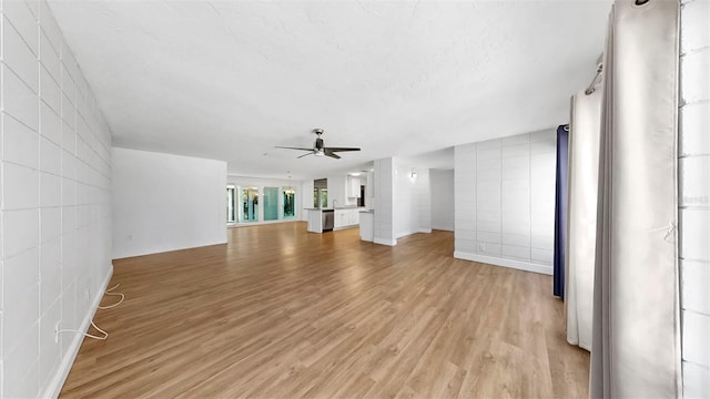4455 Emerald Ridge Dr, Sarasota, FL 34233 - unfurnished living room featuring light wood finished floors and ceiling fan