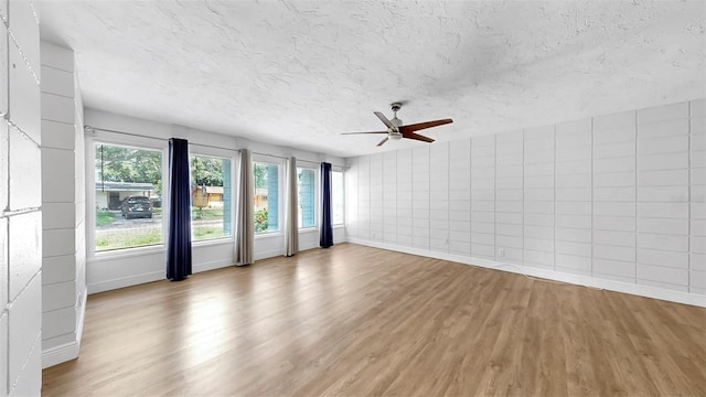 4455 Emerald Ridge Dr, Sarasota, FL 34233 - empty room featuring wood finished floors, ceiling fan, and a textured ceiling