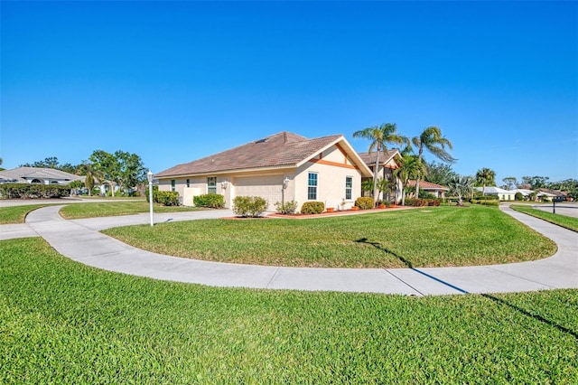 1144 Hoover St, Nokomis, FL 34275 - view of side of home featuring a yard, a garage, concrete driveway, stucco siding, and a tile roof