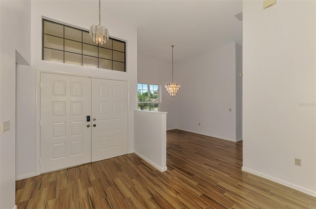 1144 Hoover St, Nokomis, FL 34275 - foyer entrance featuring a chandelier and wood finished floors