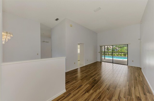 1144 Hoover St, Nokomis, FL 34275 - spare room featuring high vaulted ceiling, wood finished floors, and ceiling fan