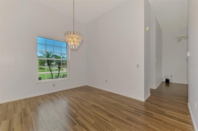 1144 Hoover St, Nokomis, FL 34275 - spare room with wood finished floors, a chandelier, and high vaulted ceiling