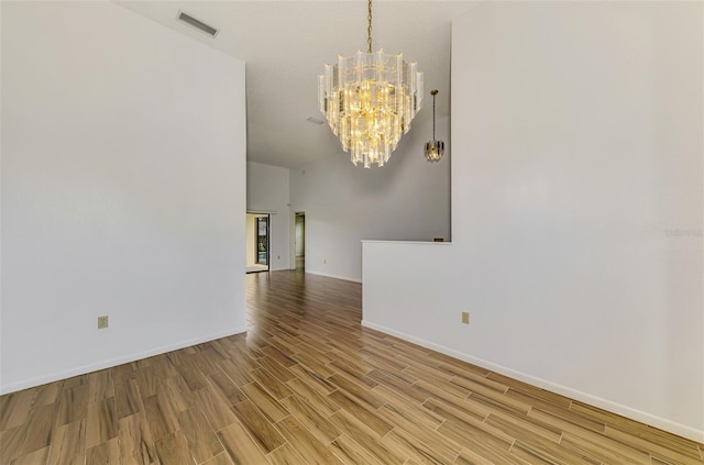 1144 Hoover St, Nokomis, FL 34275 - empty room featuring a chandelier and wood finished floors