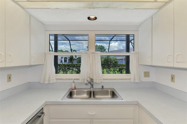 1144 Hoover St, Nokomis, FL 34275 - kitchen with light countertops, white cabinets, a textured ceiling, and stainless steel dishwasher