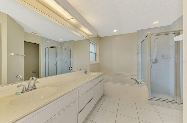 1144 Hoover St, Nokomis, FL 34275 - bathroom with a bath, tile patterned flooring, a stall shower, double vanity, and a textured ceiling