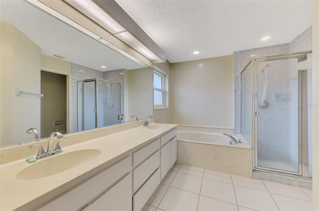 1144 Hoover St, Nokomis, FL 34275 - bathroom featuring a garden tub, a stall shower, tile patterned floors, a textured ceiling, and double vanity