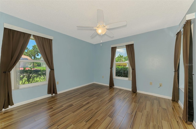 1144 Hoover St, Nokomis, FL 34275 - empty room featuring wood finished floors, a ceiling fan, and a textured ceiling