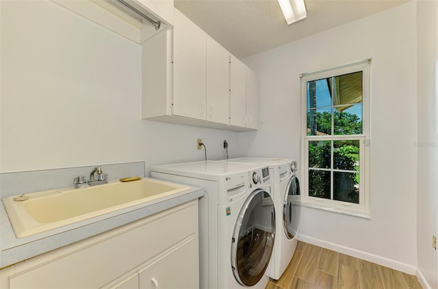 1144 Hoover St, Nokomis, FL 34275 - washroom with cabinet space, washer and clothes dryer, and light wood-style flooring
